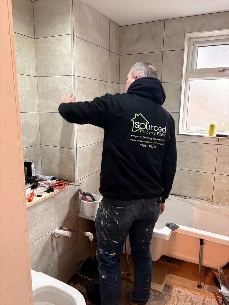 Darren working on a bathroom refurbishment in his Sourced Property Finder hoodie