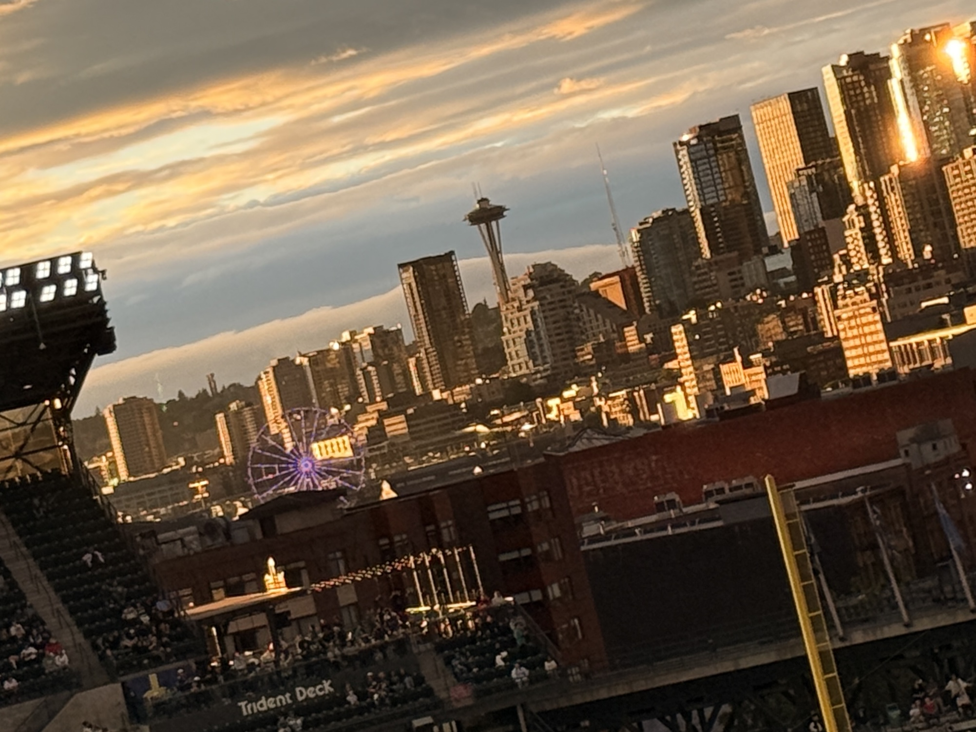 Seattle skyline at sunset from the stadium — Space Needle, Great Wheel lit up