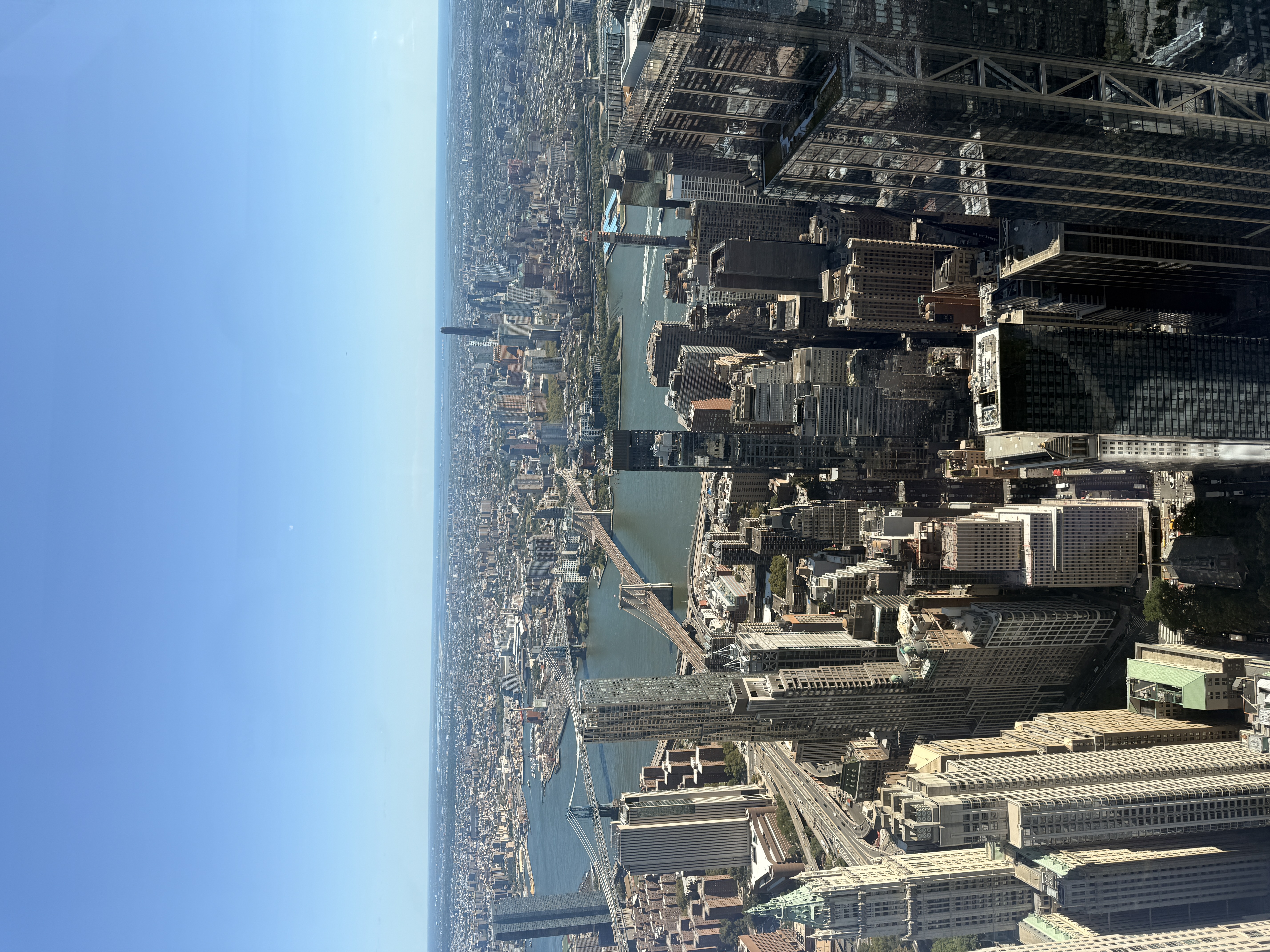 View from One World Observatory across Lower Manhattan, the East River, Brooklyn Bridge and Manhattan Bridge.