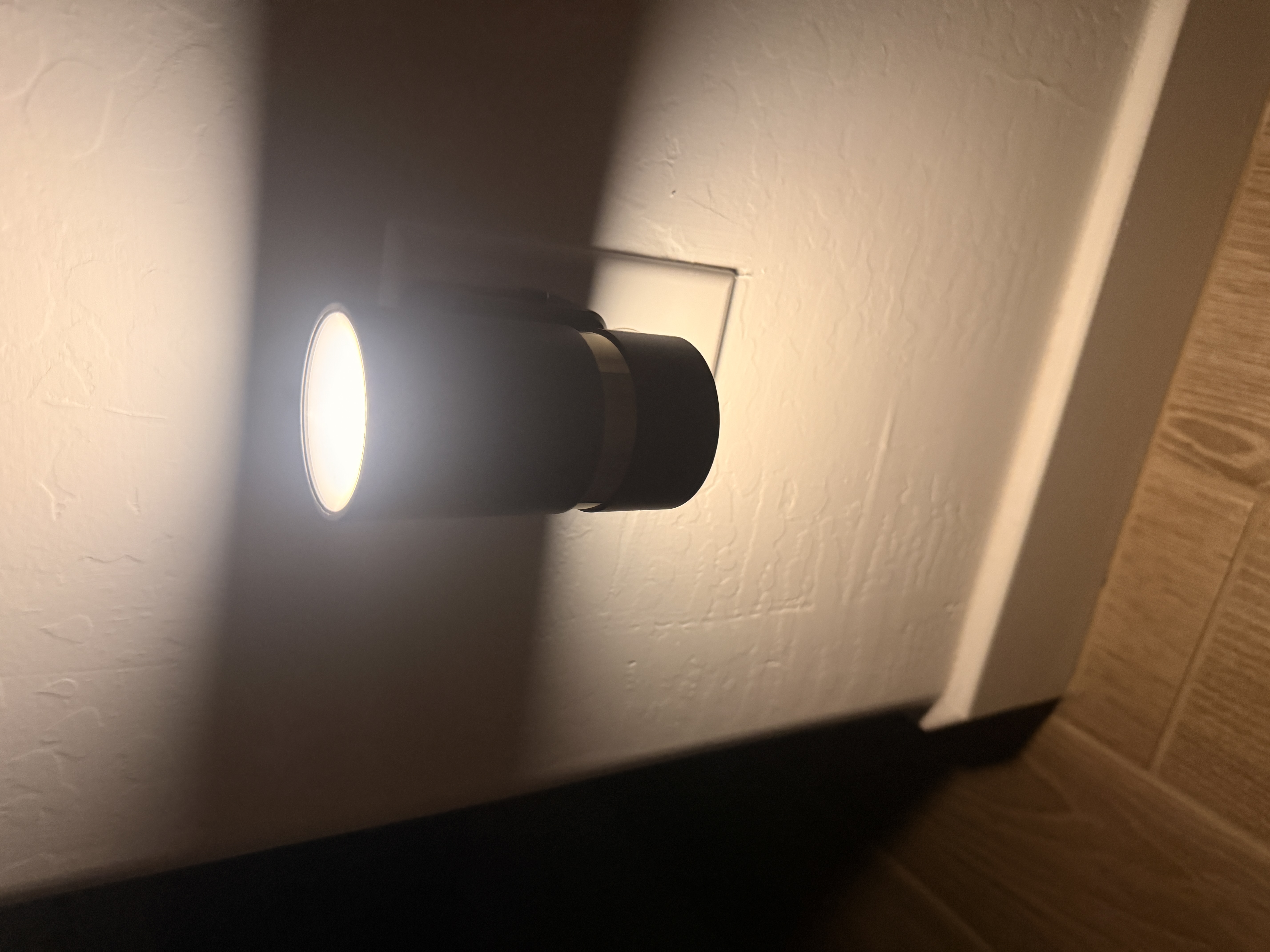Plug-in night light illuminating the wall and floor near a bedroom doorway. Plug-in night light illuminating the wall and floor near a bedroom doorway.
