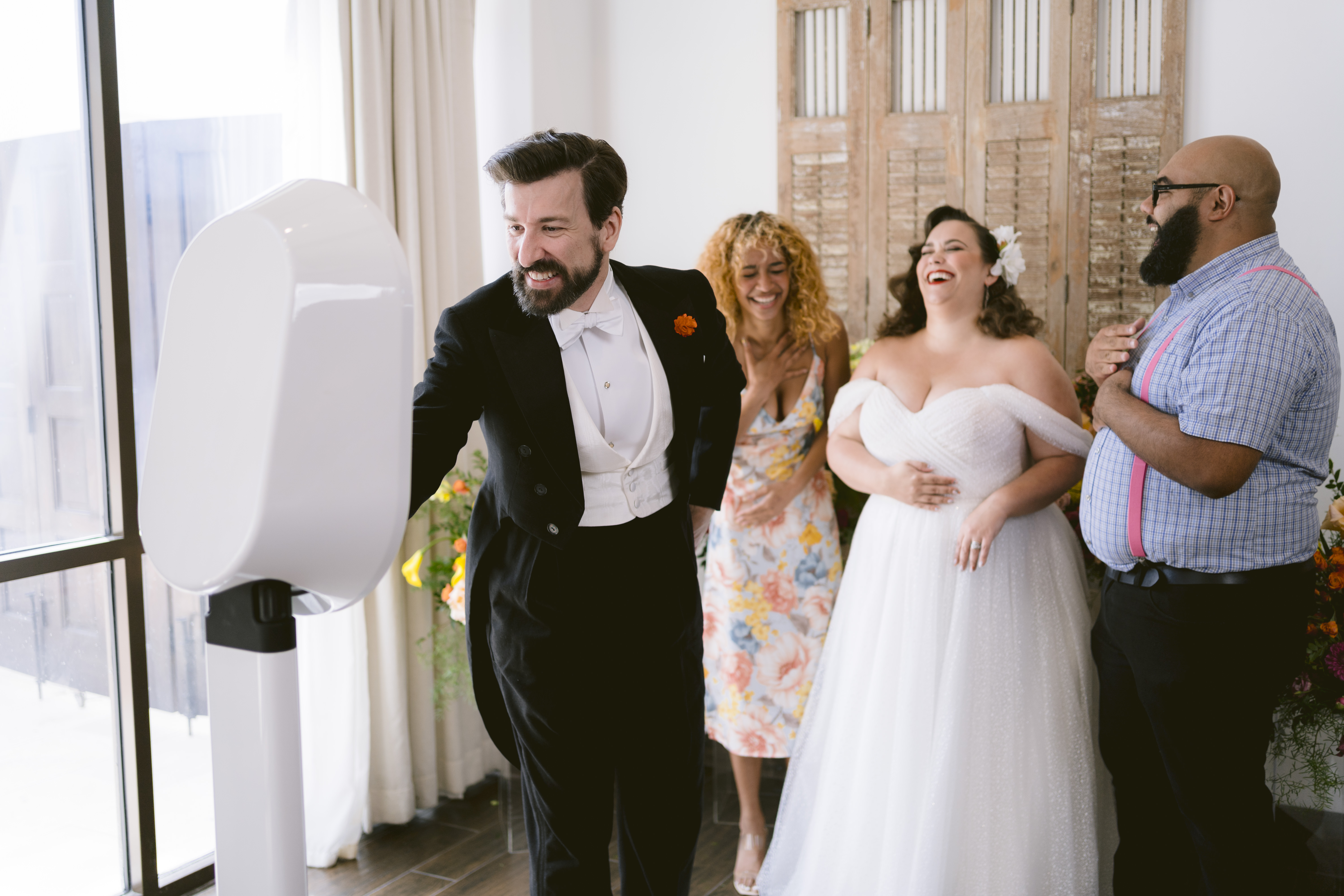people using a photo booth at a wedding 