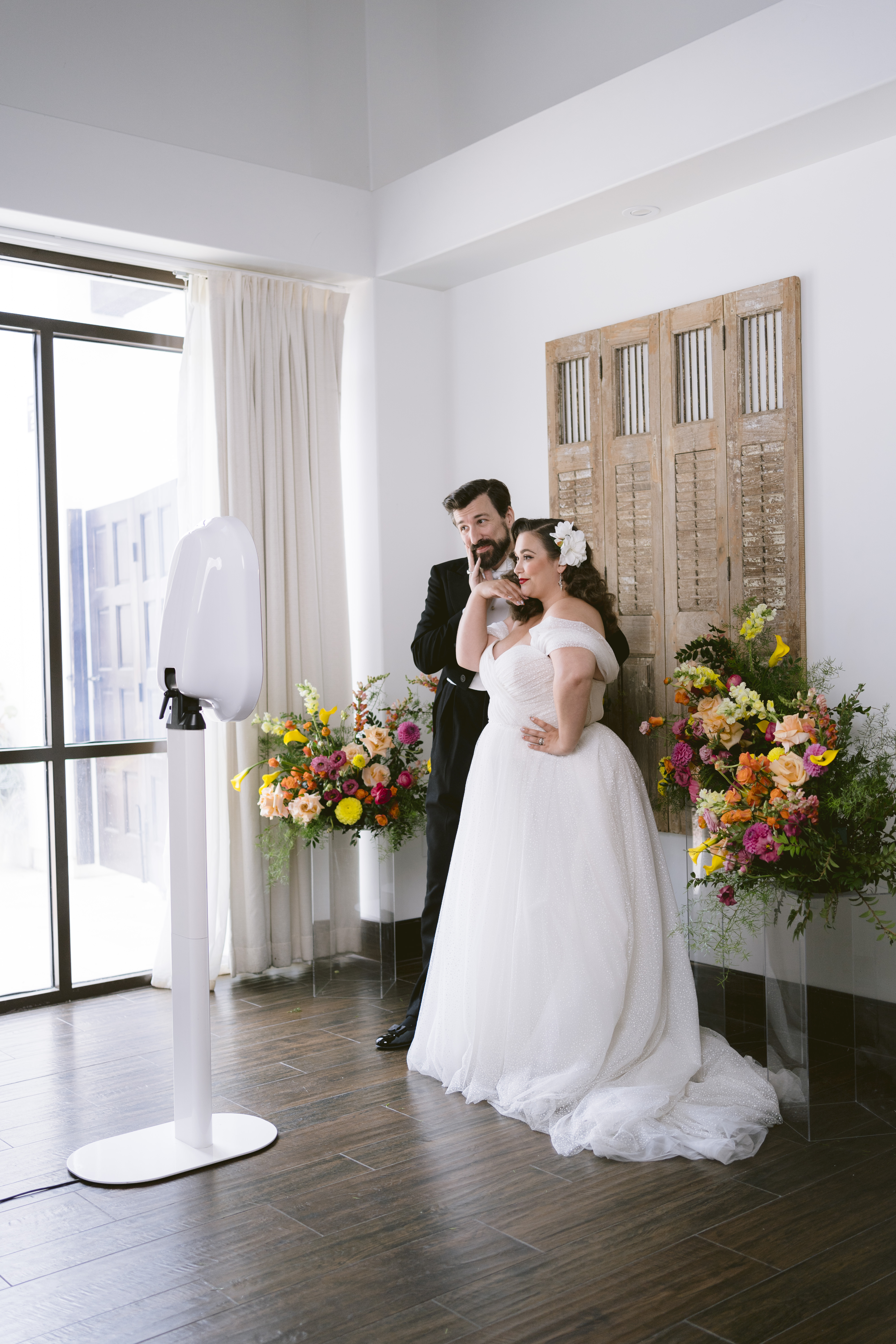 bride and groom using a photo booth at their wedding bride and groom using a photo booth at their wedding