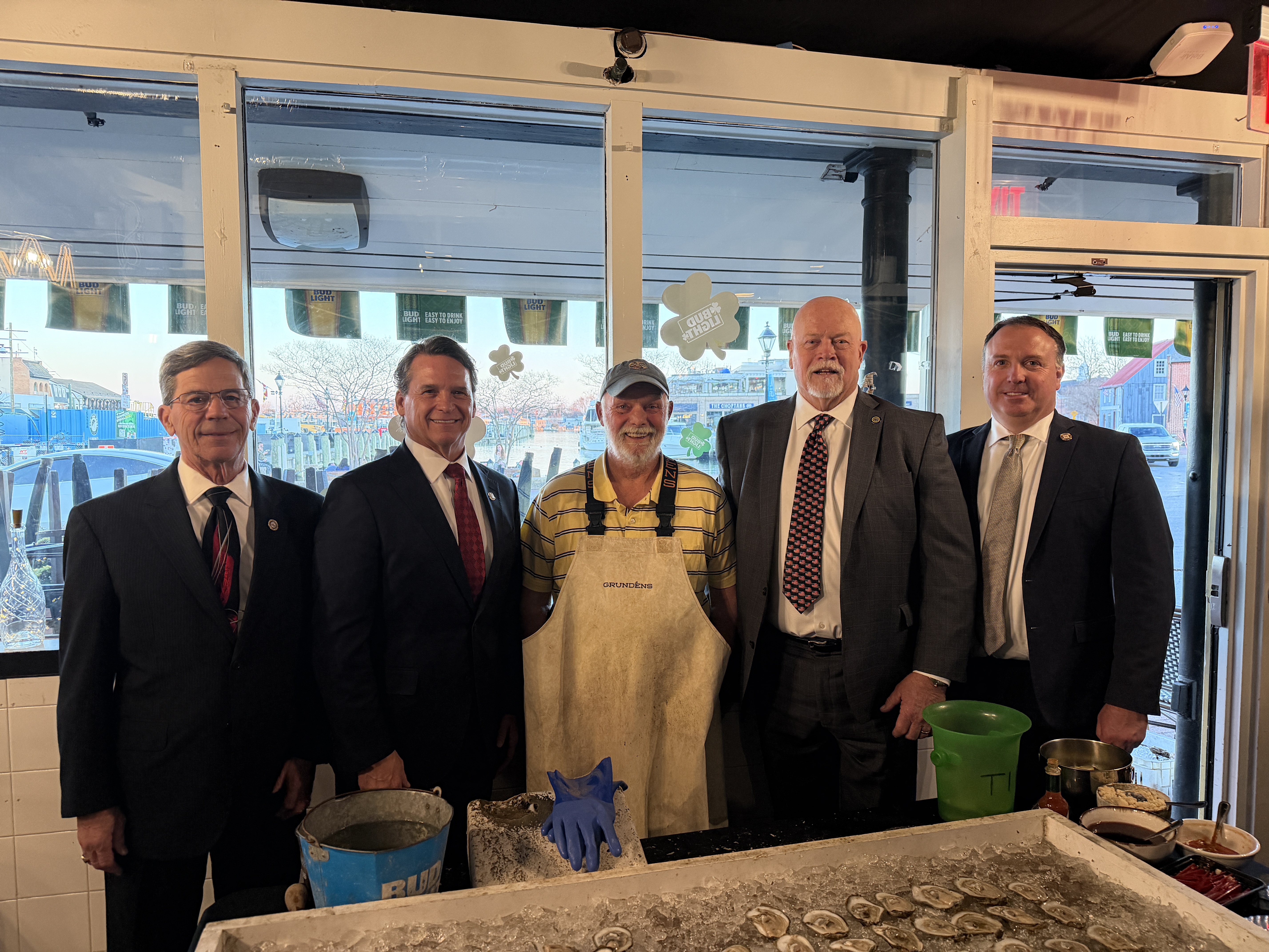 Maryland Senators and Delegates from District 36 pose with waterman.