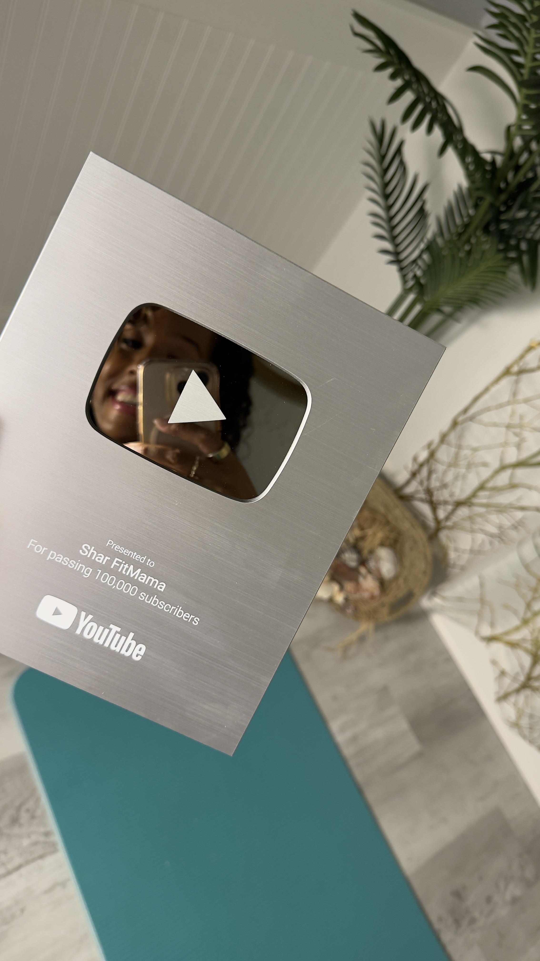 Shar holding silver play button