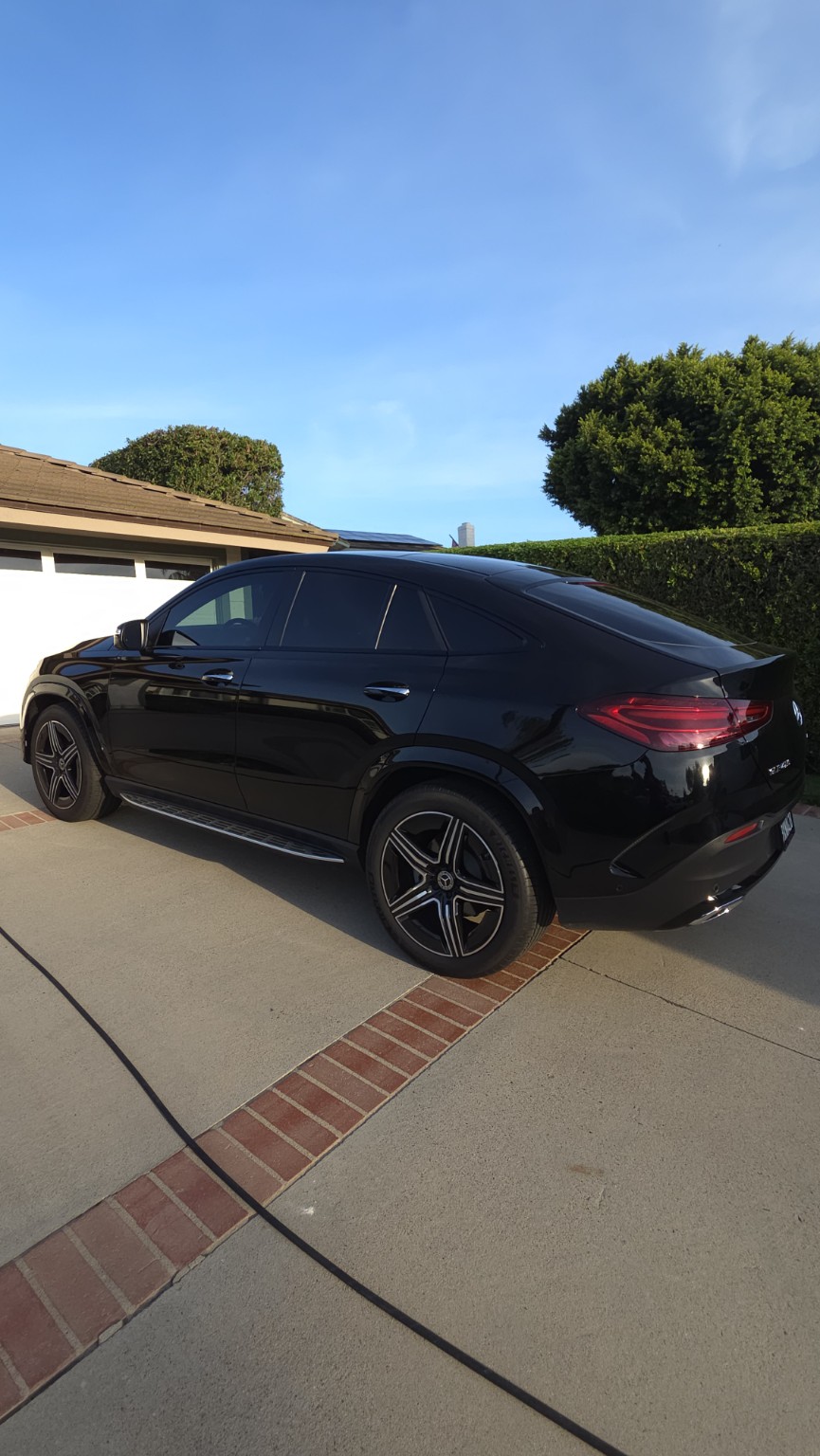 Rear three-quarter view of a black 2024 Mercedes-Benz GLE Coupe after exterior maintenance