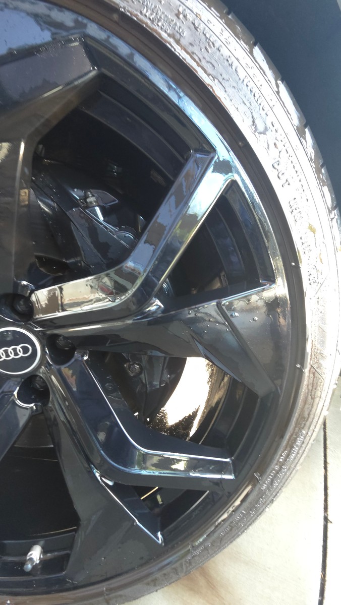 Audi RS Q8 wheel being rinsed during an exterior wash