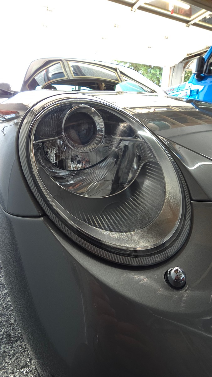 Finished Porsche headlight after headlight PPF installation.