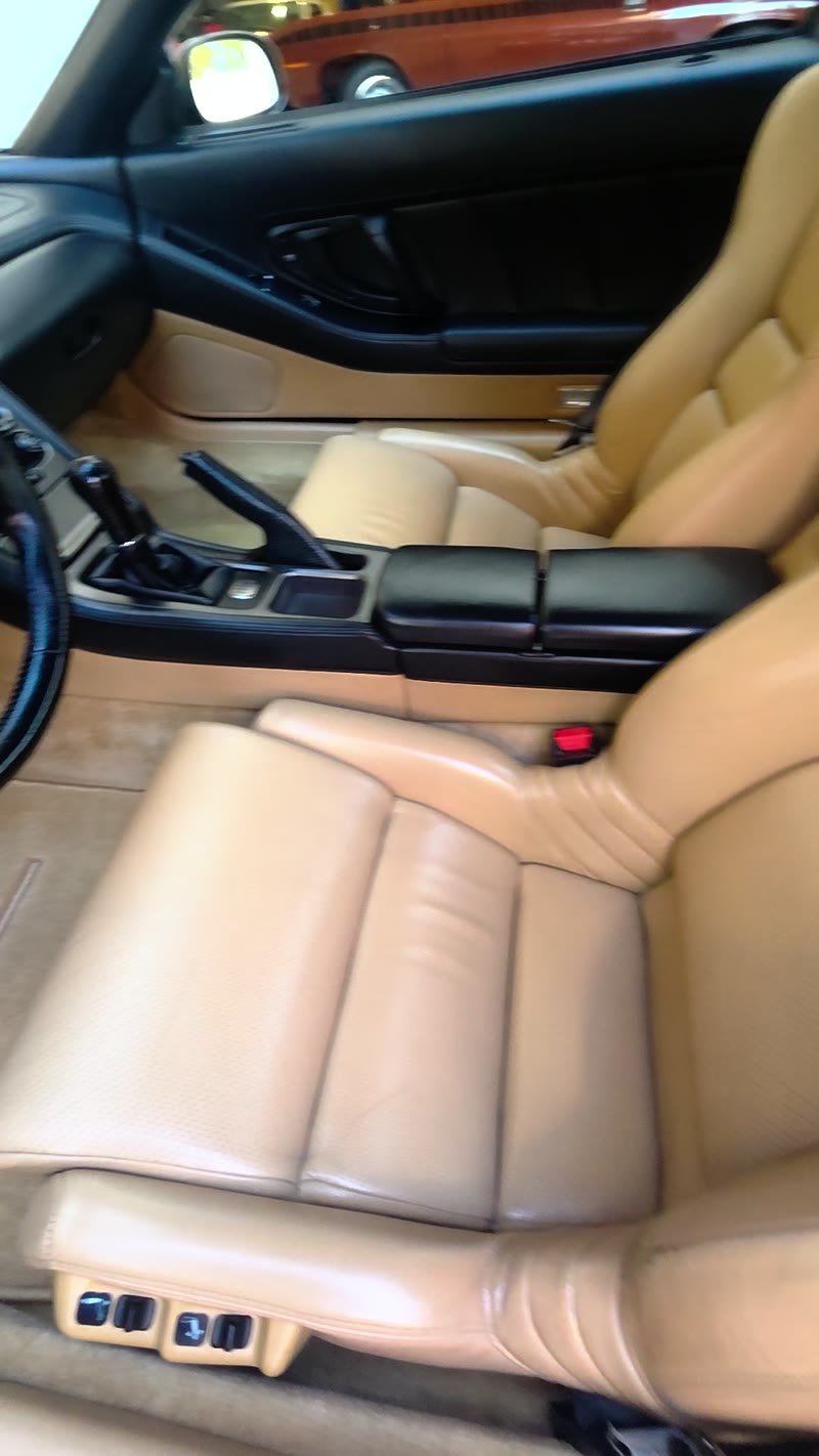Beige seats, manual shifter, and center console of the Acura NSX after interior cleaning.