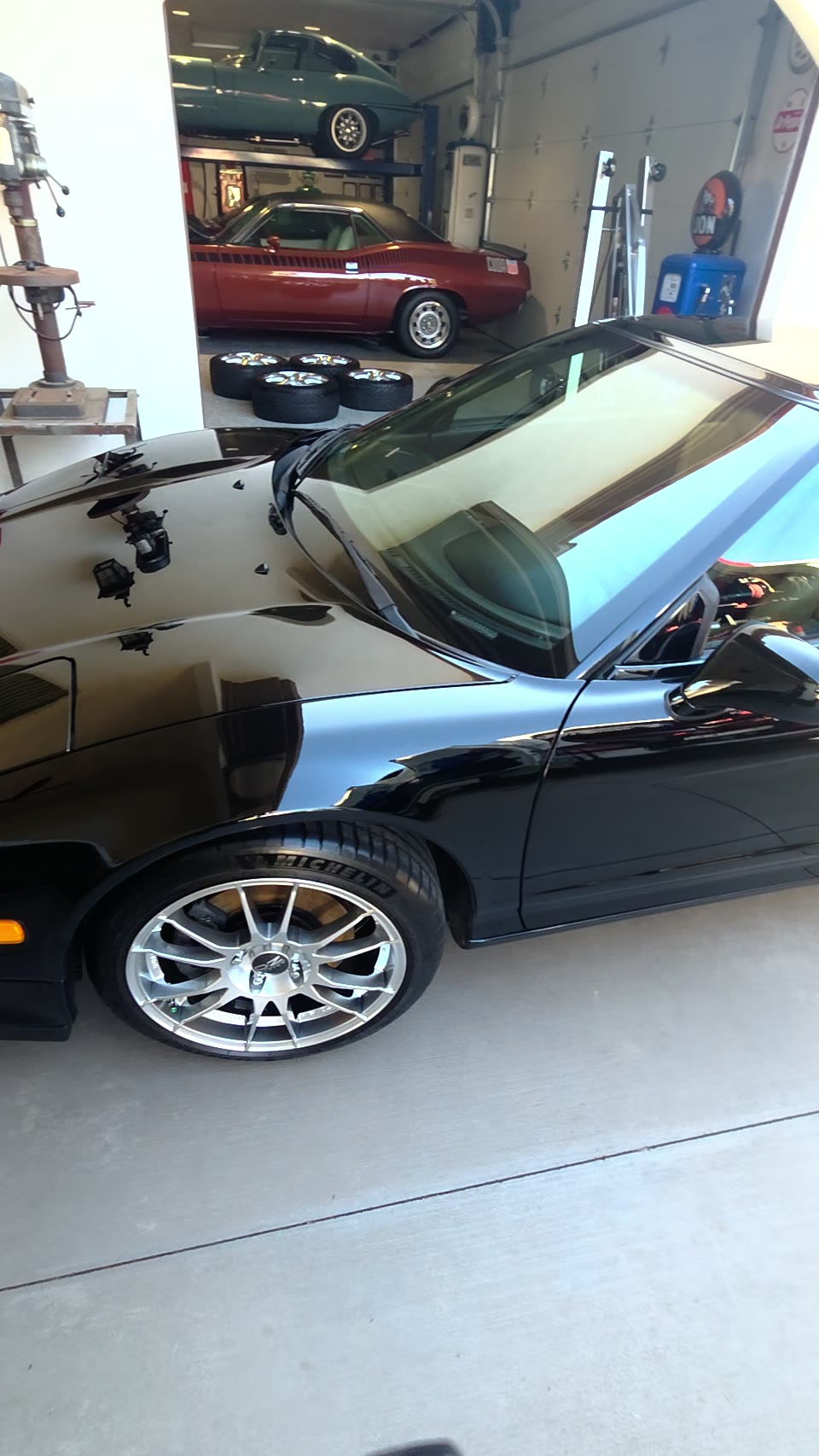 Front quarter and side of the dark Acura NSX after its exterior detail, with the silver front wheel visible.