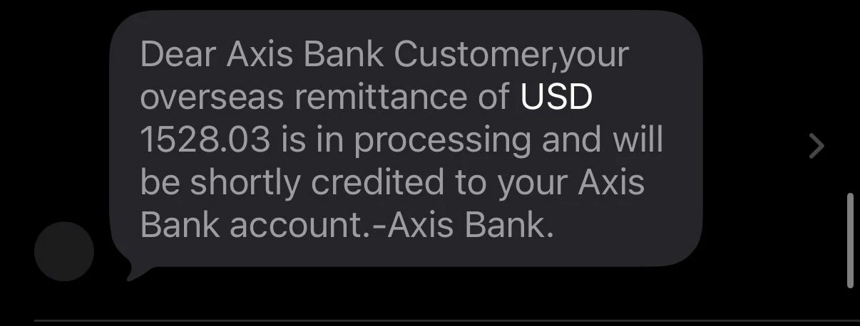 Axis Bank SMS showing USD 1528.03 remittance