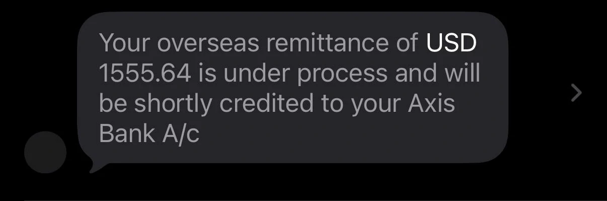 Axis Bank SMS showing USD 1555.64 remittance