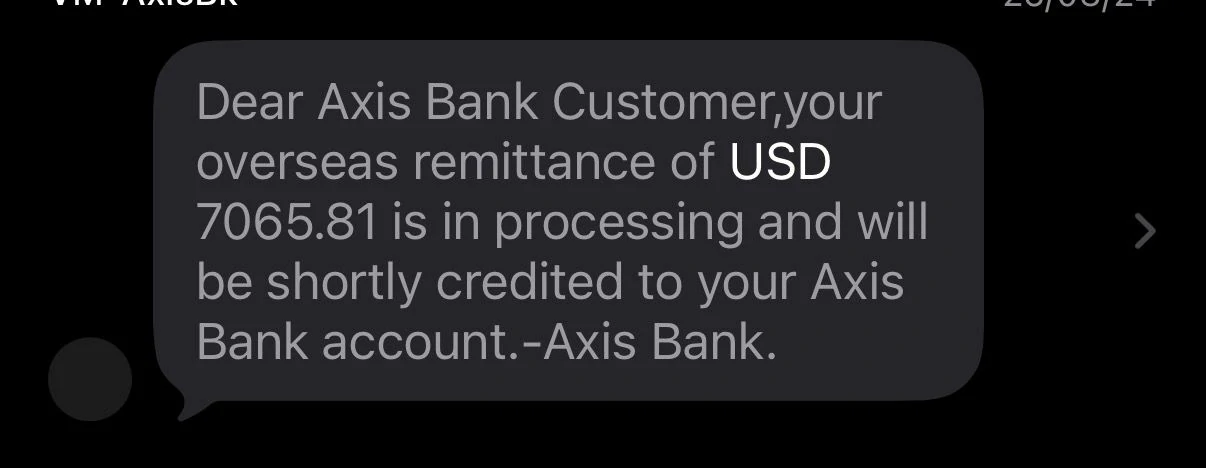 Axis Bank SMS showing USD 7065.81 remittance