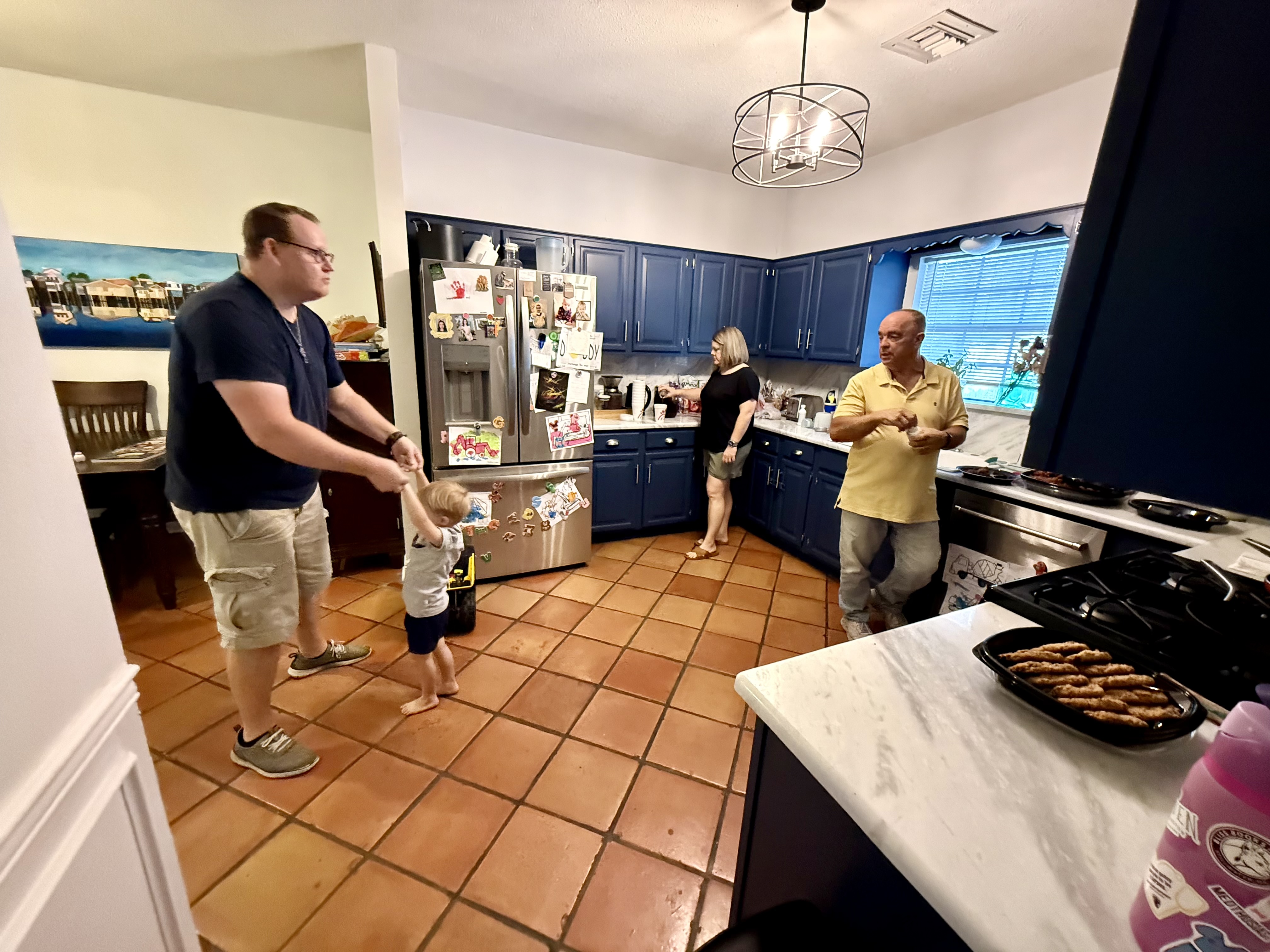 A family sharing life together around the kitchen