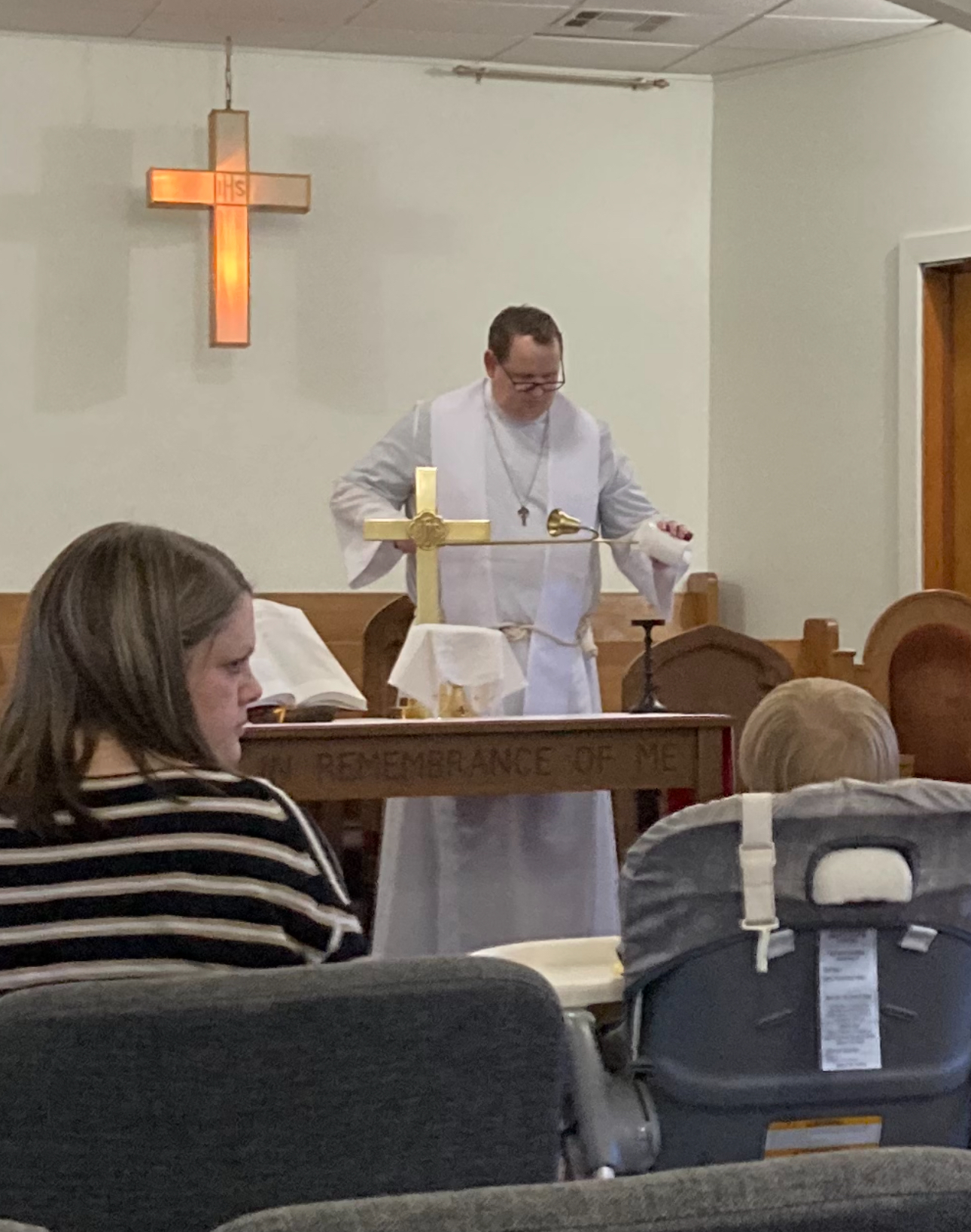 Father Andrew Hollingsworth standing before the altar at a Church of the Holy Trinity service
