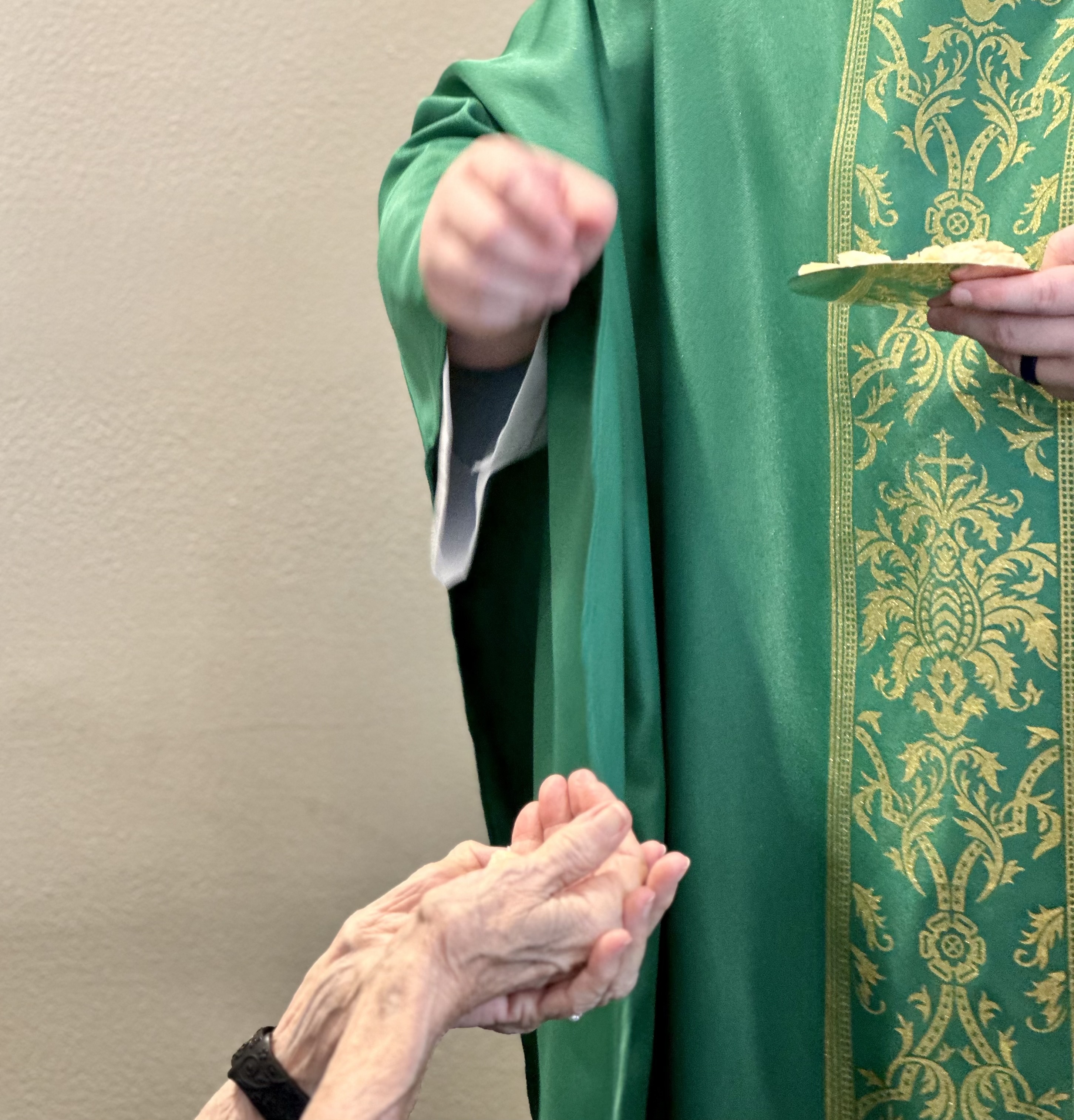 A priest celebrating communion during a Church of the Holy Trinity gathering
