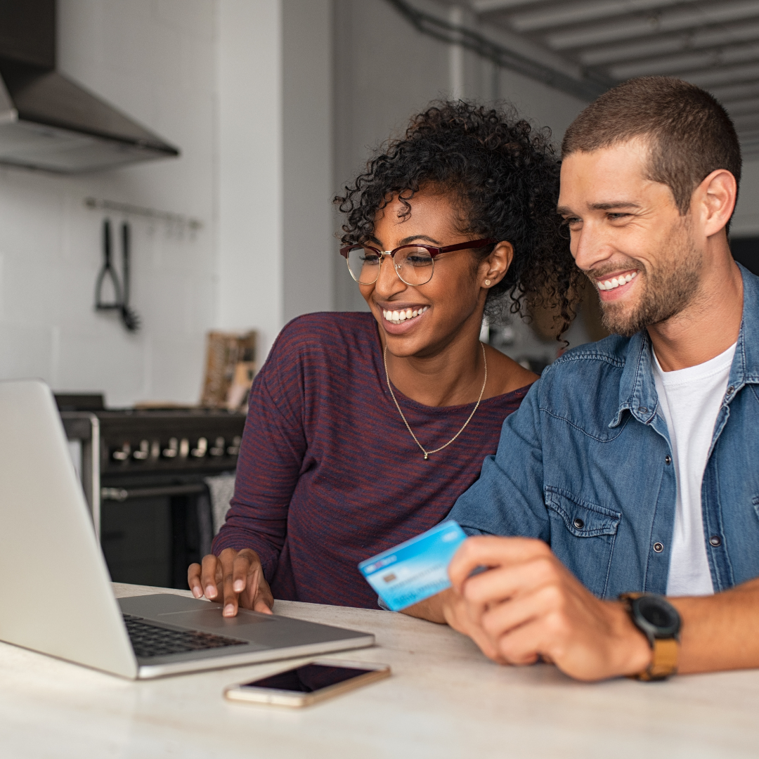 Woman in bright living room looking out window at neighborhood view reflecting homeownership vision