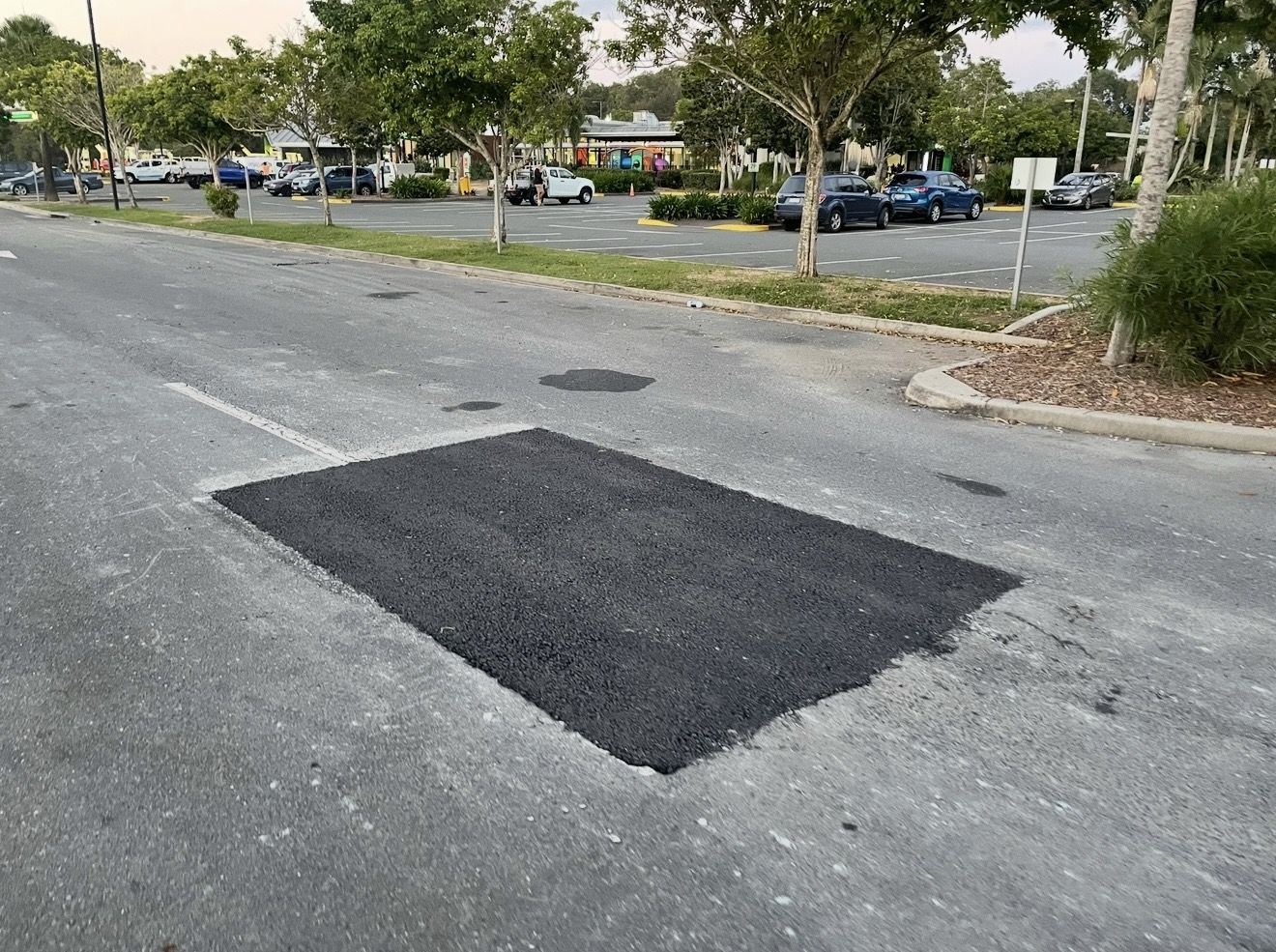 Finished hot mix asphalt repair rolled flush with the surrounding surface