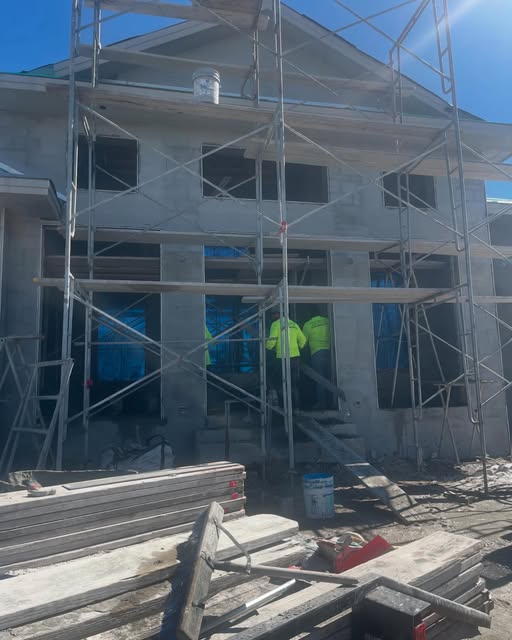 Multi-story home under construction with scaffolding