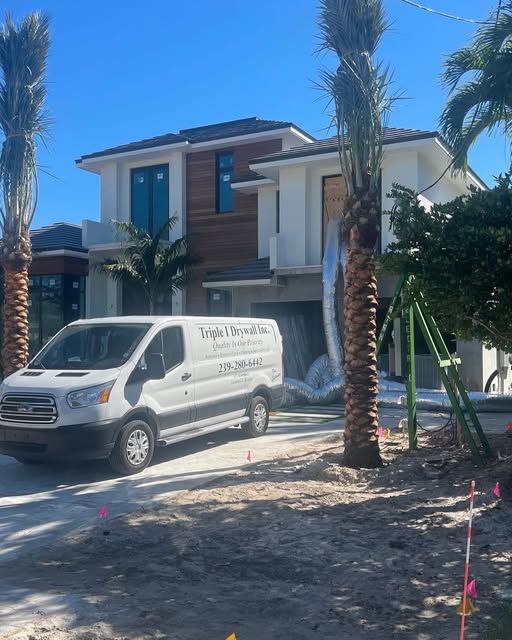Triple I Drywall van at a new-construction job site