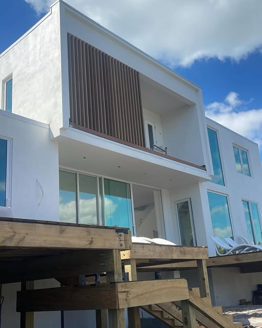 Modern white stucco home with wood accent