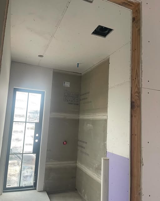 Interior drywall hung around a glass door