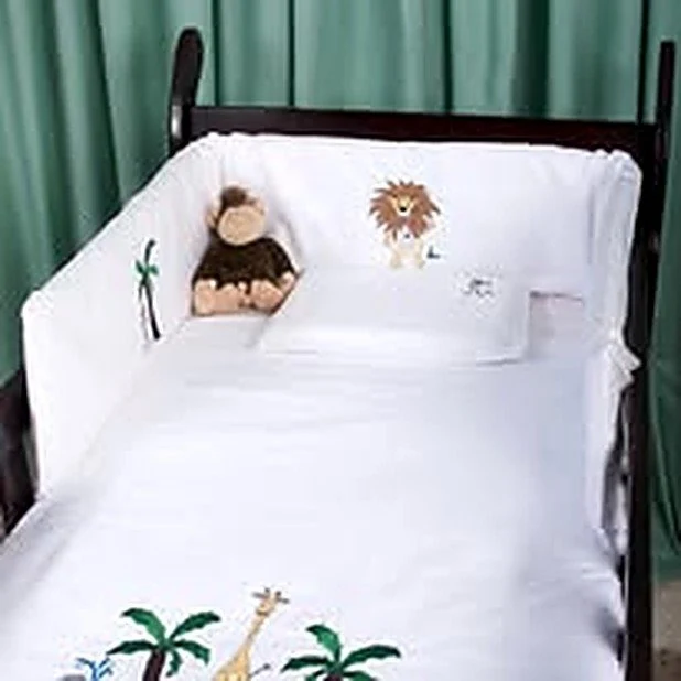 The original Jungle George embroidered cot linen from 2007, with the lion, monkey and giraffe stitched on