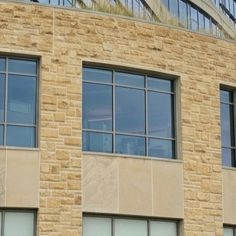 After facade cleaning by WindowClean by Vertex showing restored commercial stone facade with a cleaner exterior finish