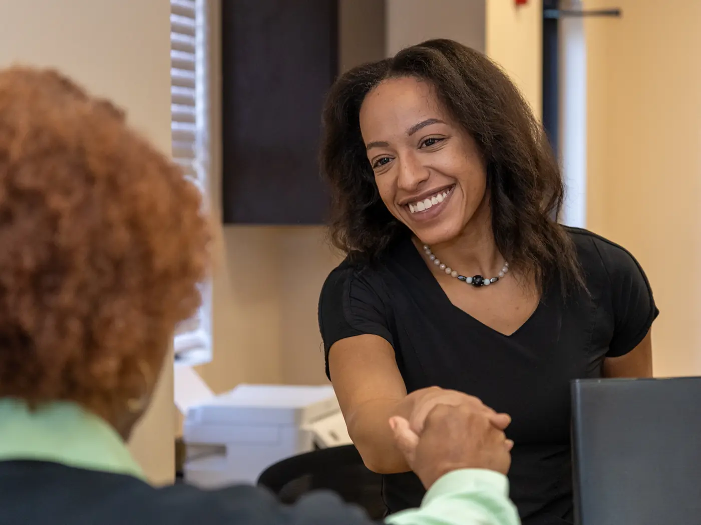 A Parkway Dental Care team member welcoming a patient at the front desk