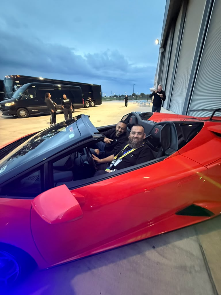 Sitting in a red sports car outside the hangar during LevelUp week