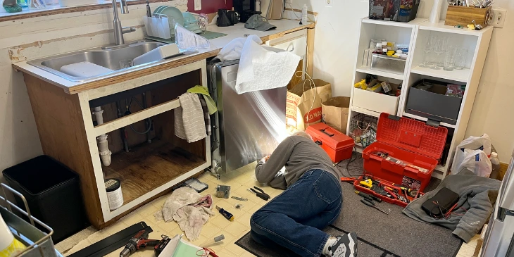 A kitchen fitter remodelling a kitchen