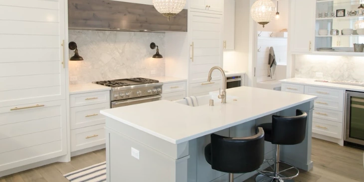 An open kitchen, with an island countertop in the middle so meal preparation is easier An open kitchen, with an island countertop in the middle so meal preparation is easier
