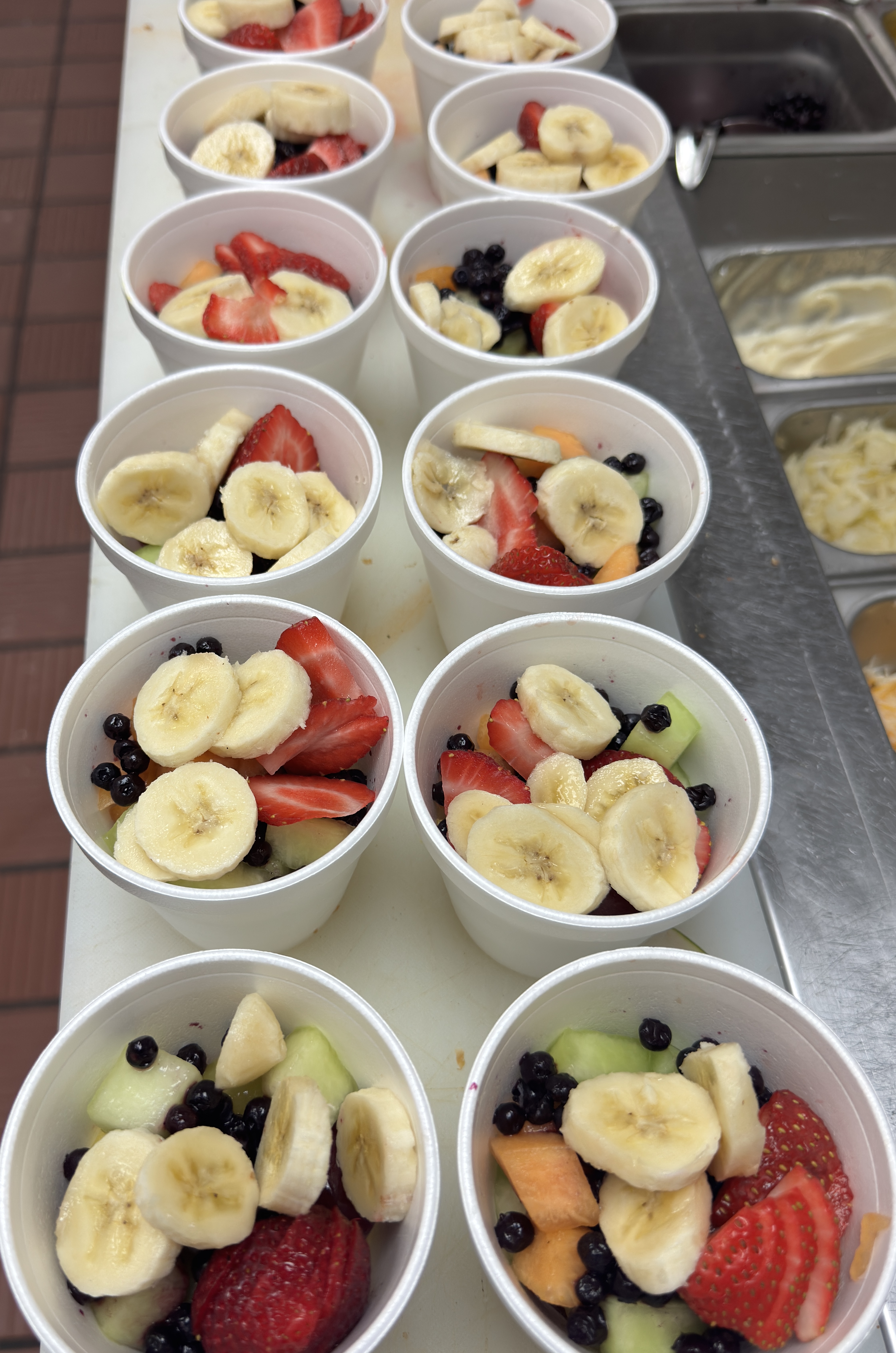 Fresh fruit cups with strawberries, bananas, blueberries and melon at The Better Biscuit