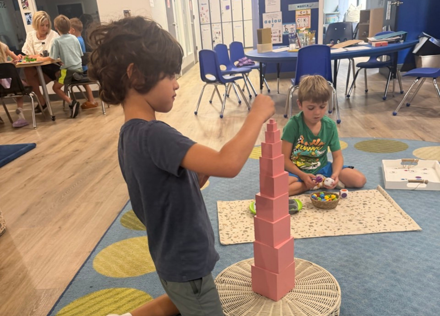 A Spark learner working with the pink tower