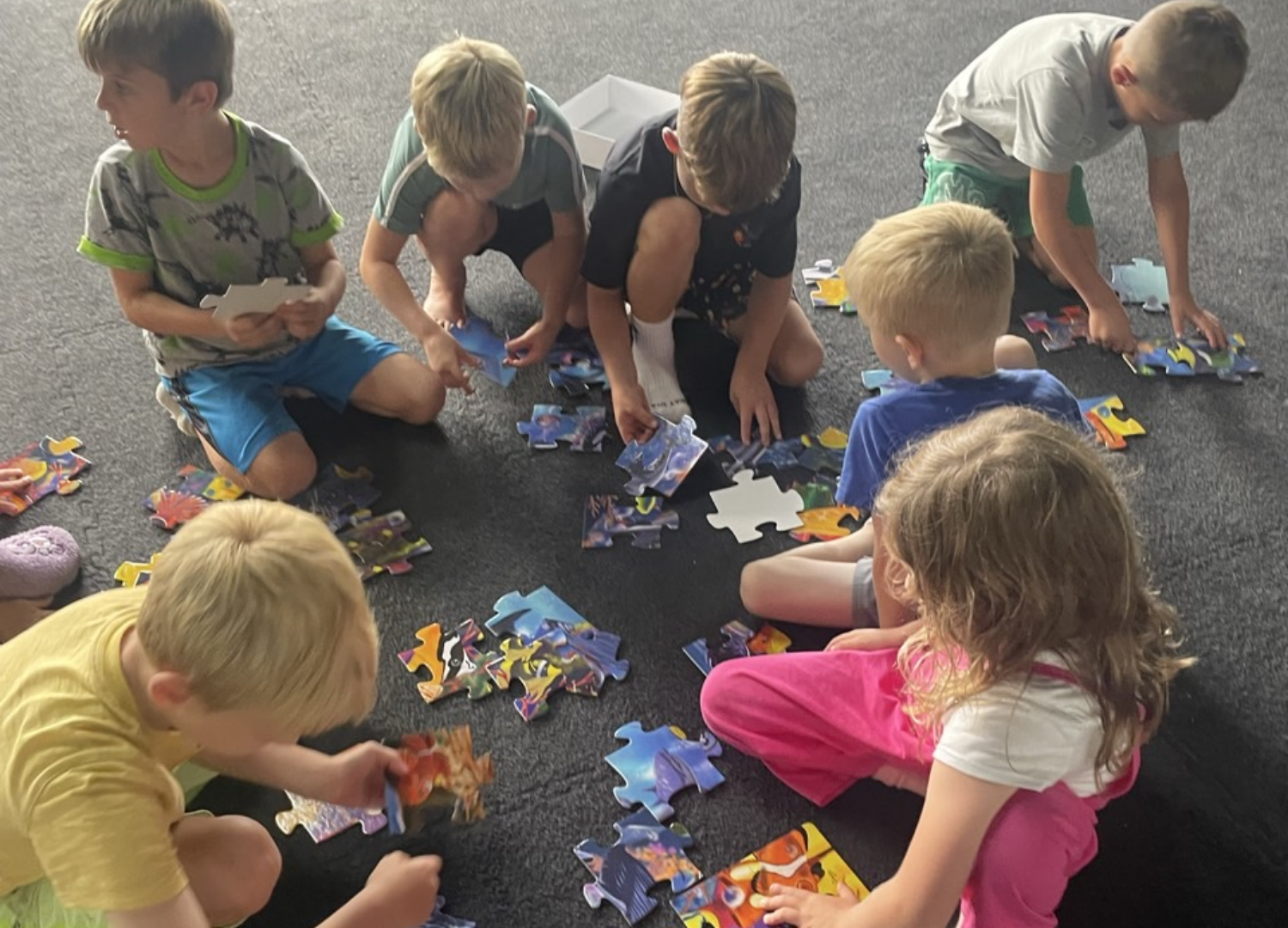 Spark learners on the floor with a puzzle