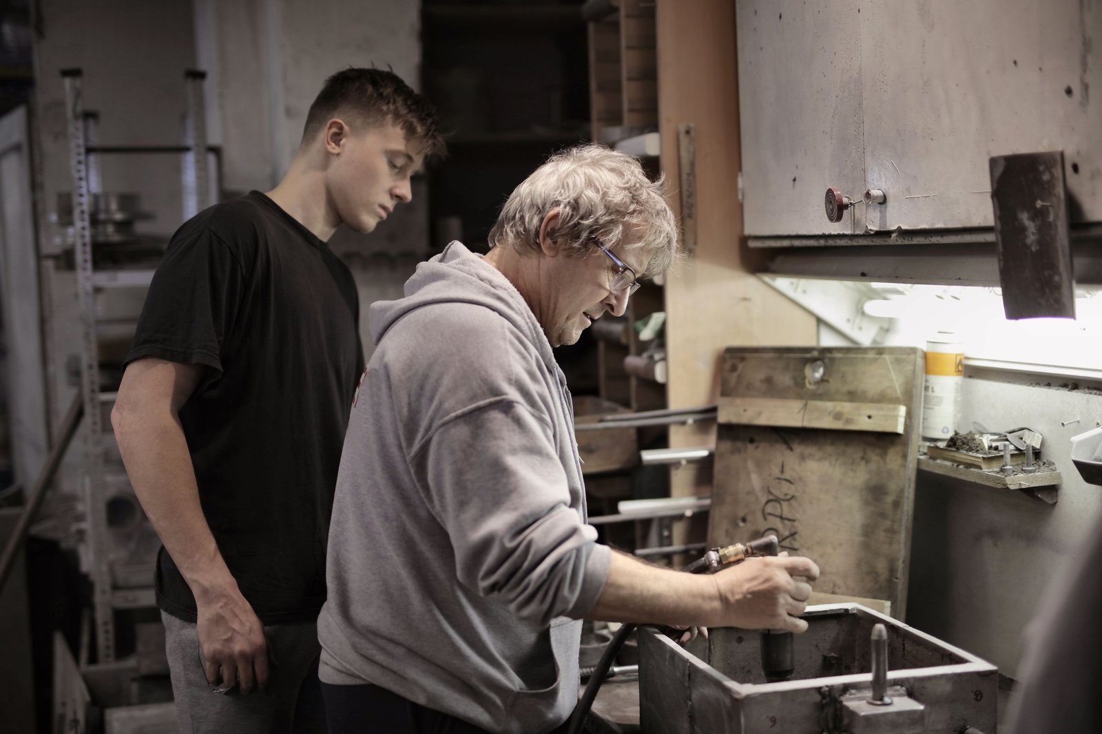 Teen and adult working together in a workshop