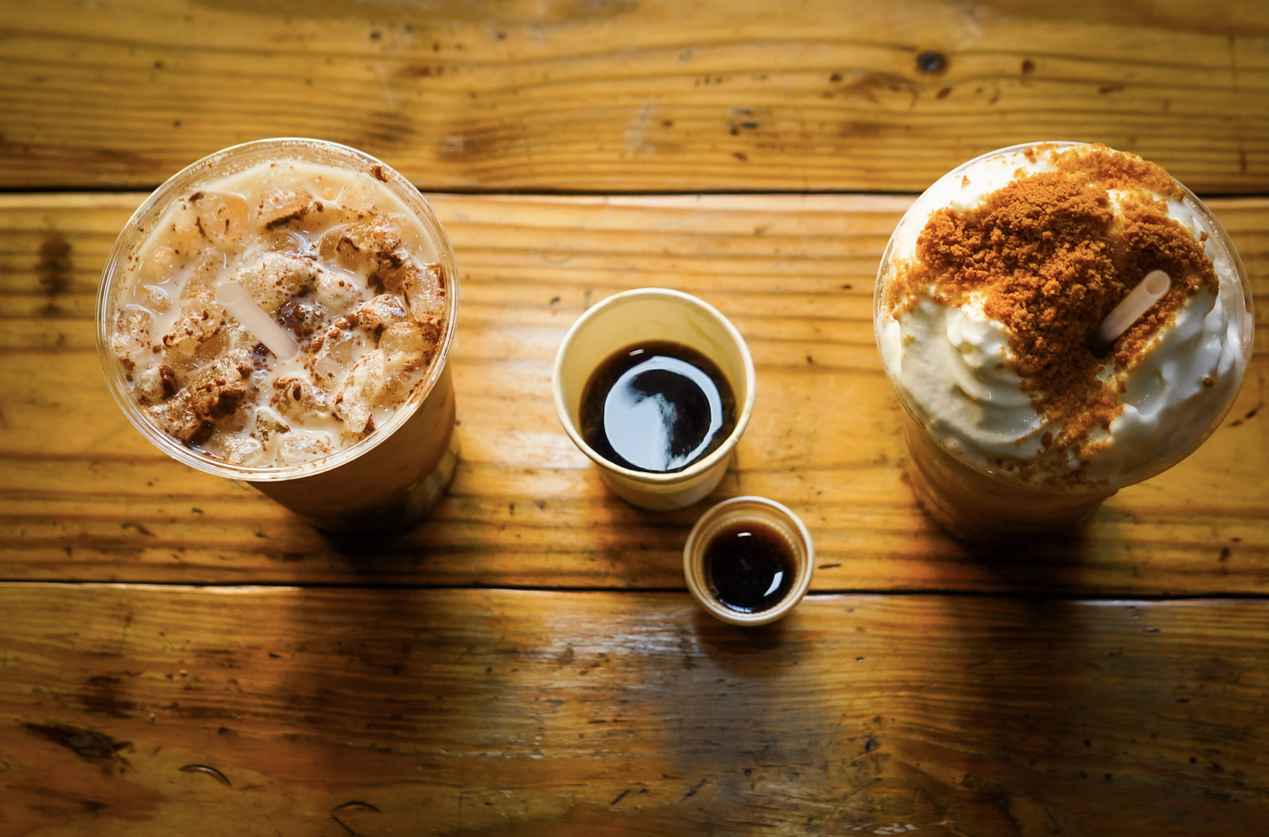 Iced Cuban coffee drinks, colada and espresso shot on a wood table