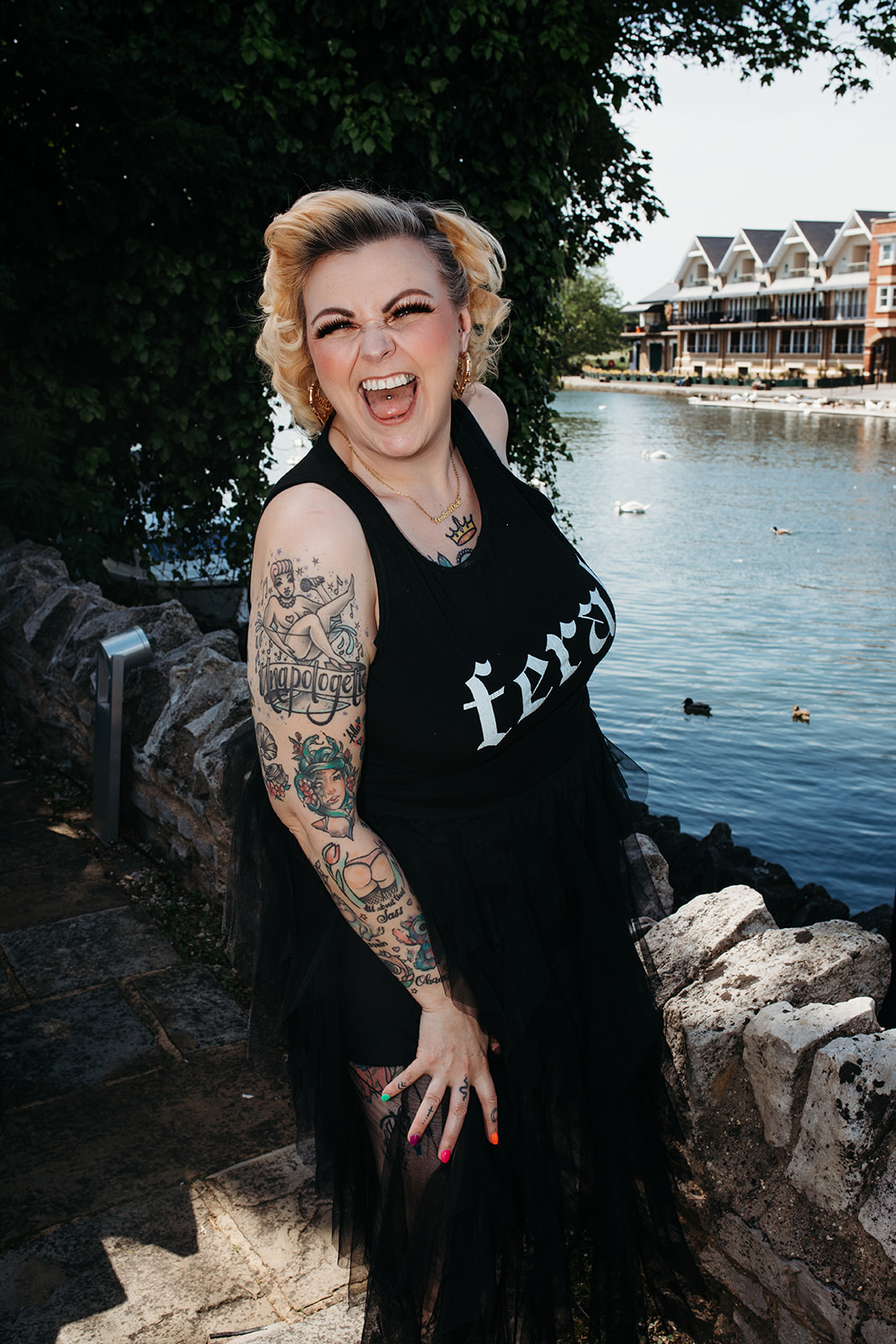 Kim Antrobus laughing by the river in a feral t-shirt