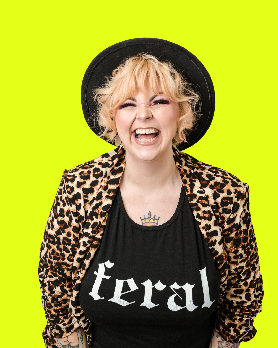 Kim Antrobus of Next Level Woman laughing in a leopard print jacket and black hat