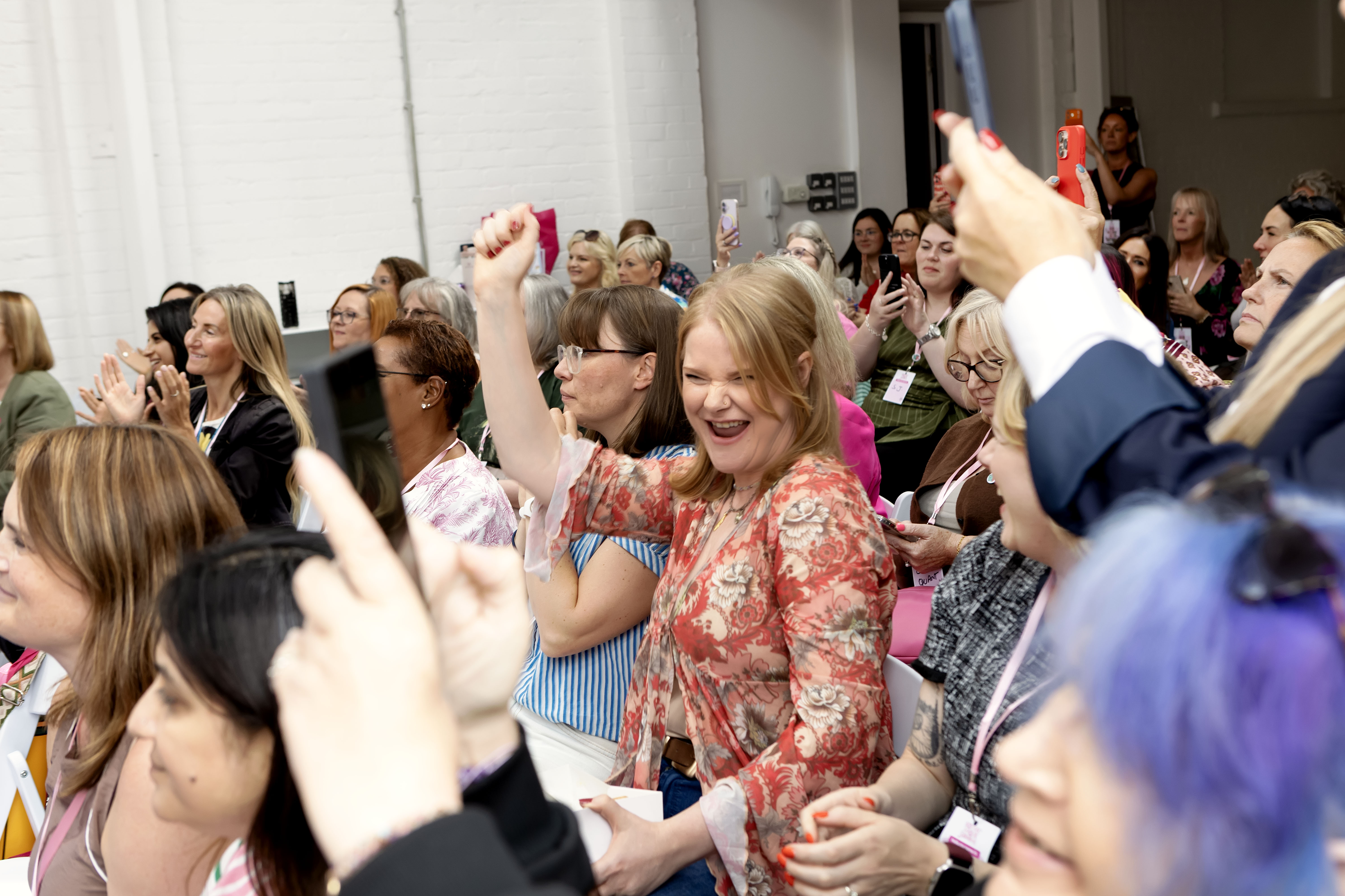 Audience cheering and raising their hands during Kim Antrobus's talk at Social Media School 2026
