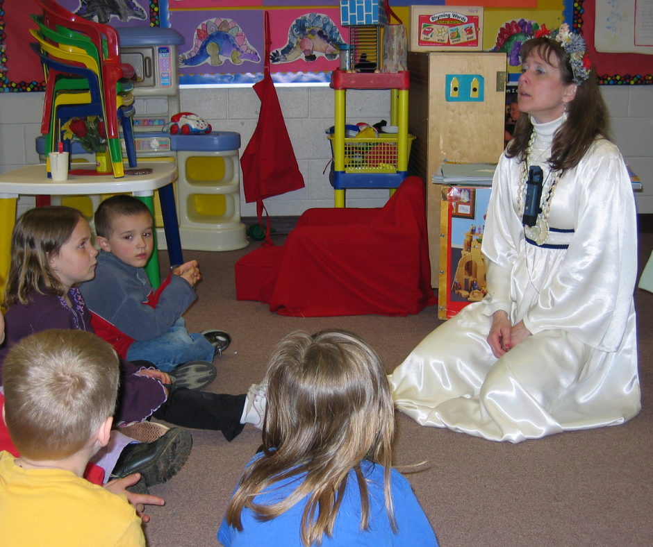 Actual photo of author teaching kindergarteners dressed up as Mother Nature for Earth Day.