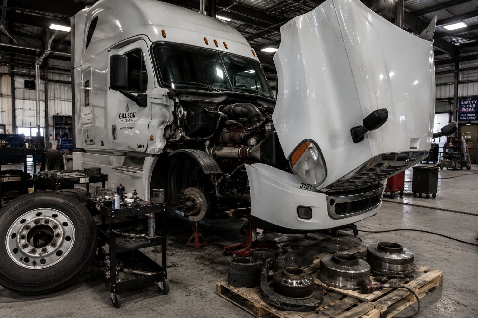 Freightliner Cascadia receiving heavy duty truck parts maintenance in Ontario fleet yard