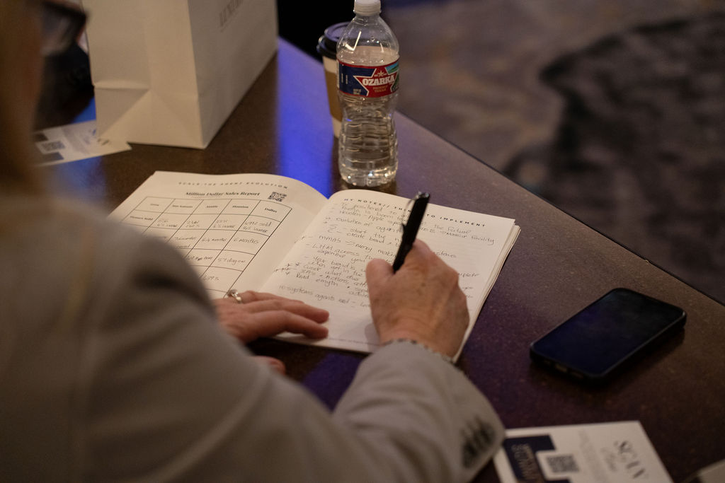Attendee writing in workbook