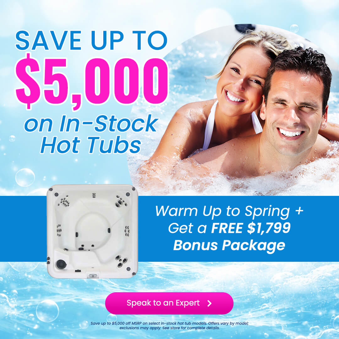 Couple relaxing together in a bubbling outdoor hot tub at night, highlighting a hot tub sale starting at $9,995 with a bonus package valued at $2,500 and free accessories included.
