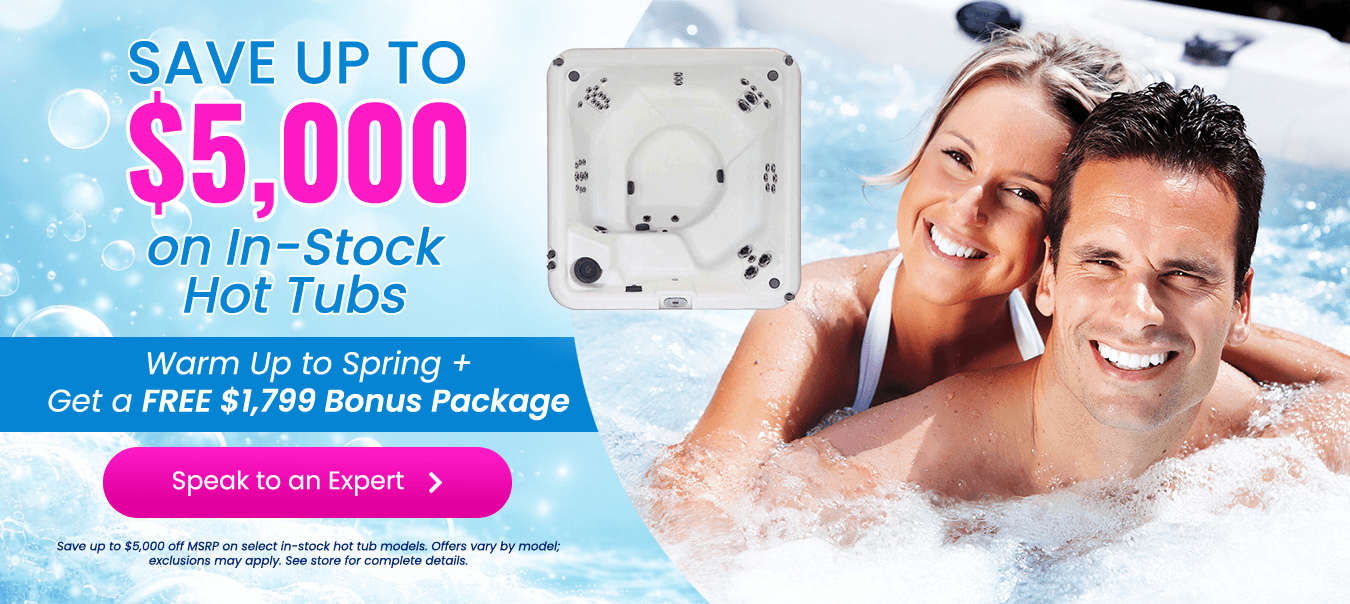 Couple relaxing together in a bubbling outdoor hot tub at night, highlighting a hot tub sale starting at $9,995 with a bonus package valued at $2,500 and free accessories included.