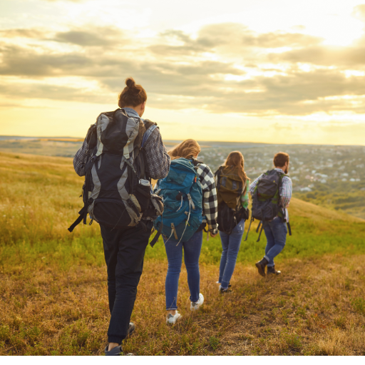 Group of backpackers hiking together on a mountain trail.