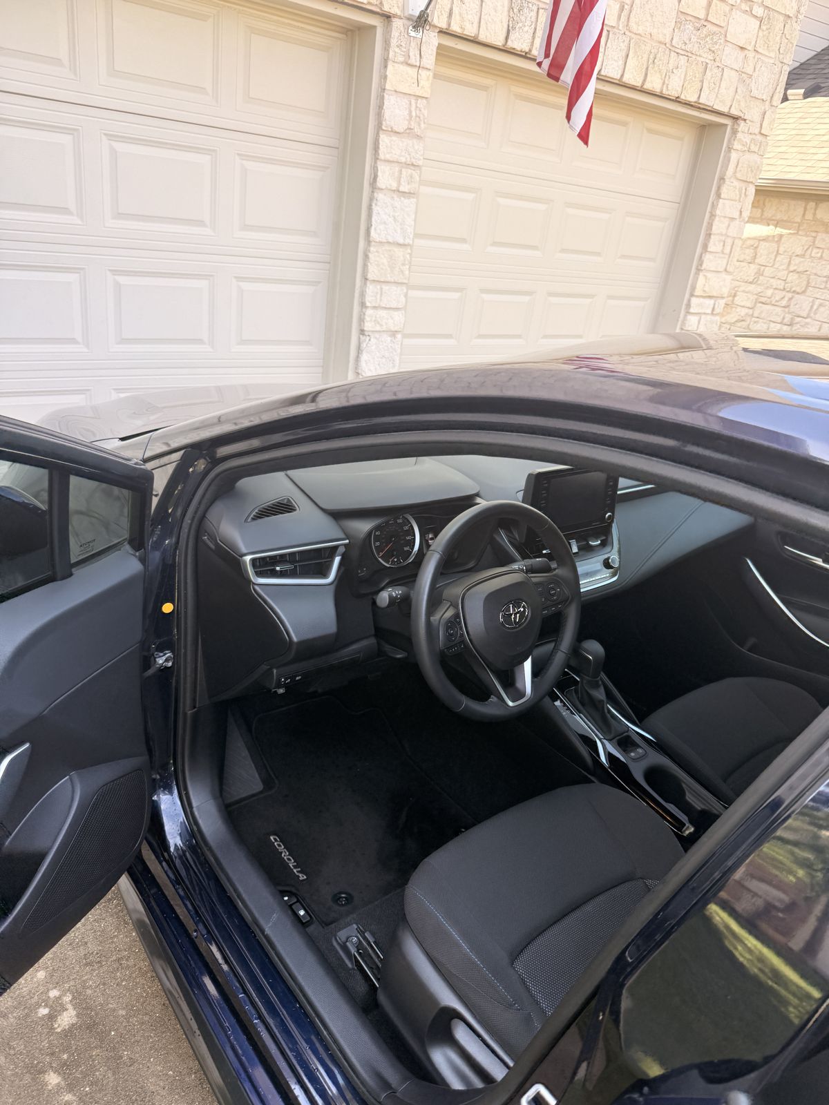 Clean, wiped-down sedan interior with door open