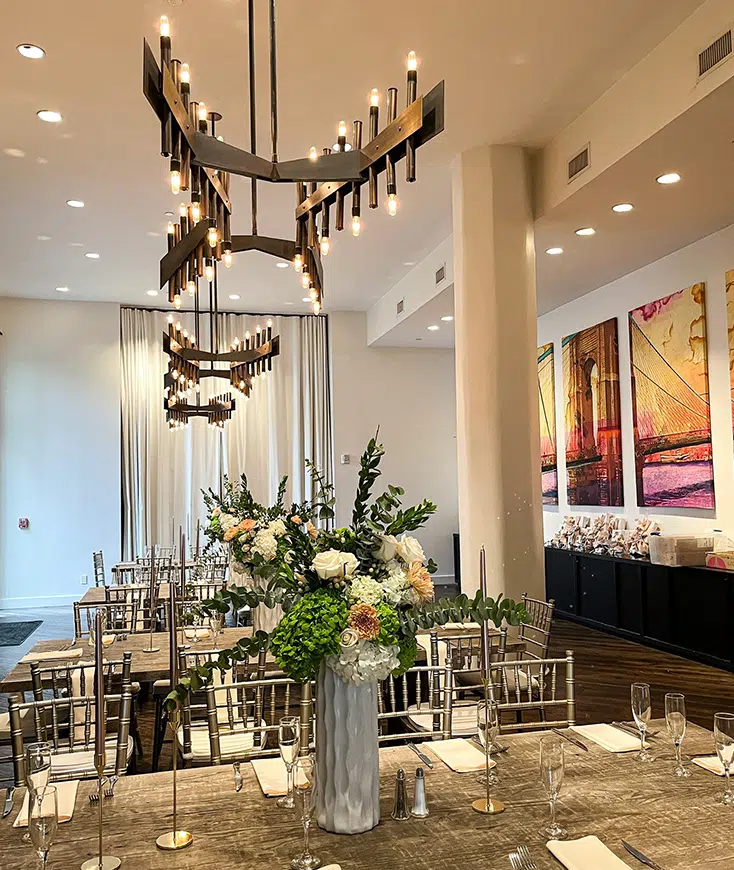A dressed table beneath the room's sculptural chandeliers