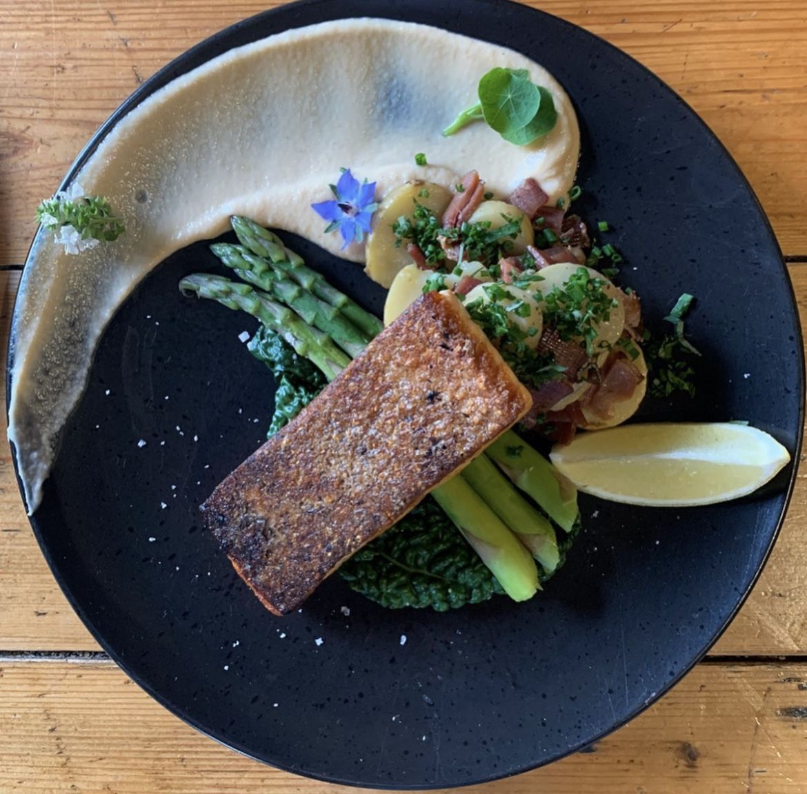 A plated dish of fish with asparagus and potato at Mintaro Restaurant