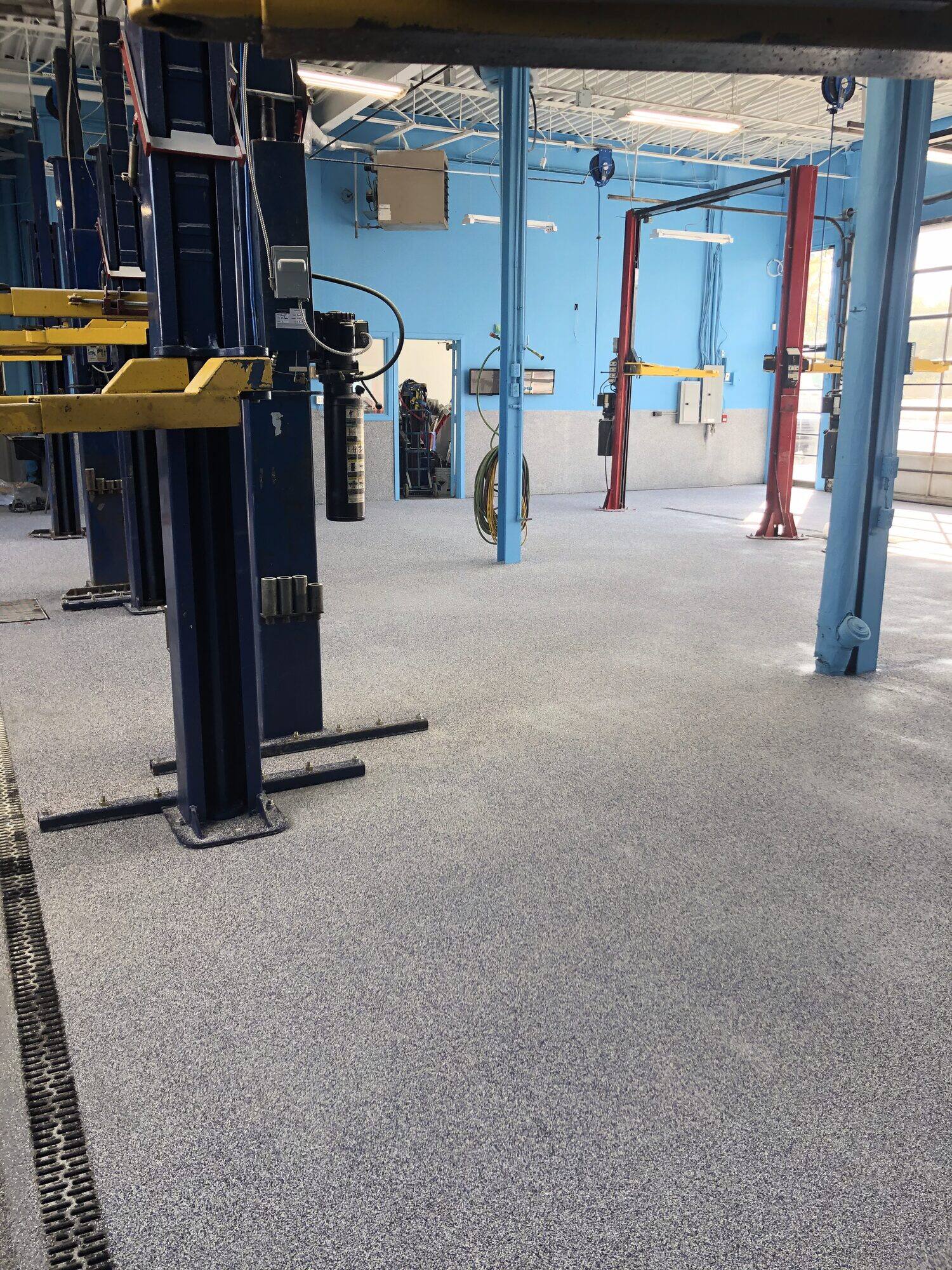 Automotive service workshop with vehicle lifts and a finished floor