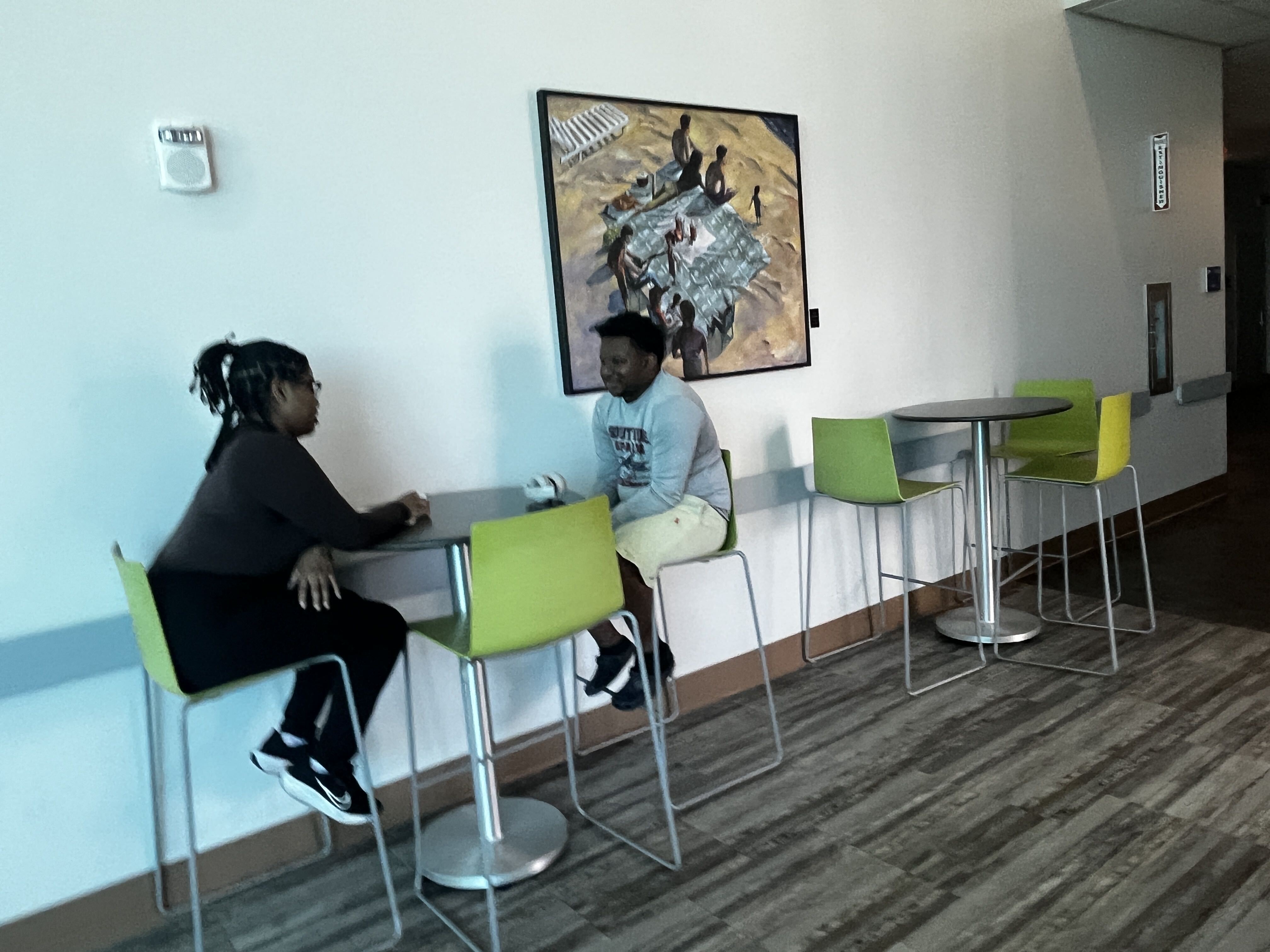 Youth peer mentor guiding a teen through a job application on a computer